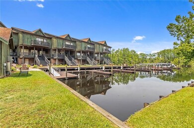 Dock area with a water view and a lawn