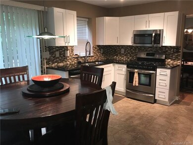 Updated Kitchen with New Kitchen Cabinetry, Countertops and Backsplash.  Stainless appliances including Gas Range, Microwave Oven and Refrigerator.