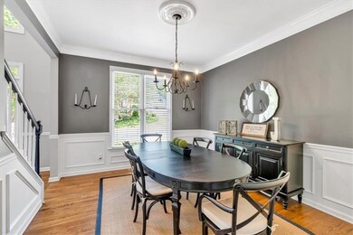 Dining room with a notable chandelier, light wood-