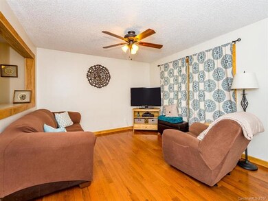 Cozy living room next to kitchen and breakfast bar