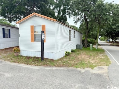 View of property exterior with central AC unit and driveway