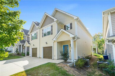 View of front of home featuring a garage and concrete driveway