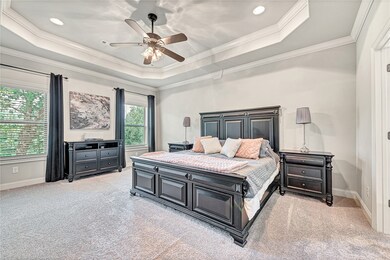 Master suite overlooking the privacy of your backyard w/ access to the covered deck.