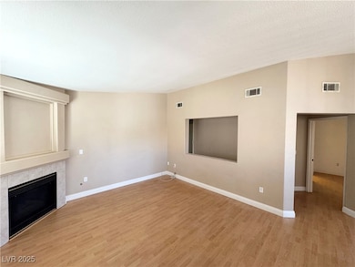 Unfurnished living room featuring light wood-style