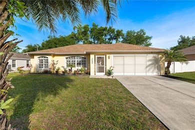 Single story home with a front yard and a garage