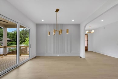 Unfurnished dining area featuring a chandelier, li