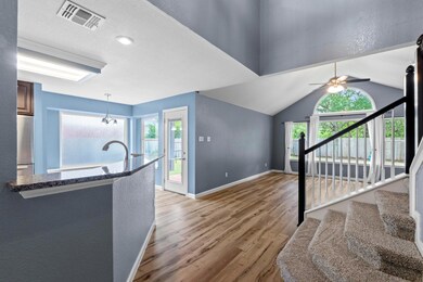 Kitchen featuring freestanding refrigerator, ligh