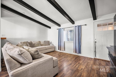 Living room with wood finished floors and baseboards