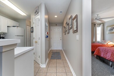 Hallway featuring light tile patterned floors