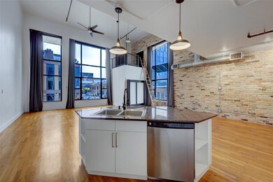 Kitchen featuring stainless steel dishwasher, a s