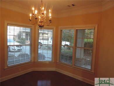 Dining area has wood flooring and lots of windows.