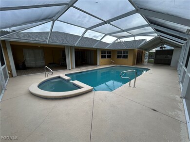 View of pool featuring a sunroom, a patio, a pool with connected hot tub, and a lanai