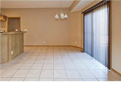 The dining room has a tile floor and opens out ont