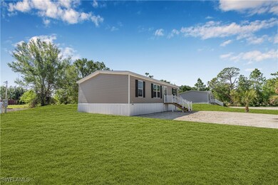 View of property exterior featuring a yard and dri