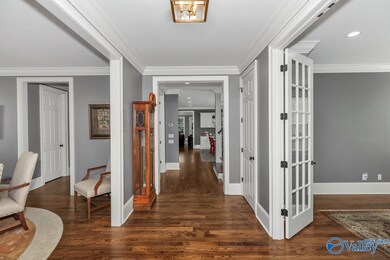 Foyer enhanced hardwood floors, crown molding and beautiful light fixture; 10 foot ceilings throughout main level