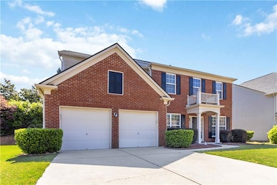 Colonial inspired home featuring brick siding, con