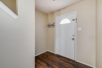 Foyer entrance featuring dark hardwood / wood-styl