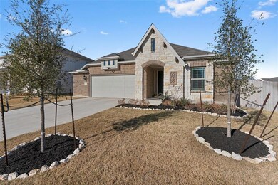 French country home featuring stone siding, a gar