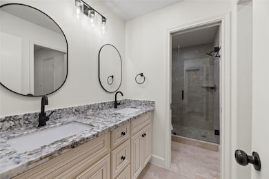 Totally remodeled primary bath with double sinks and new shower, toilets and cabinetry.