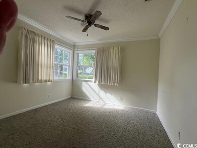 Spare room featuring a textured ceiling, carpet, c