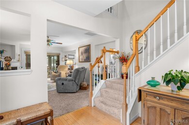 Stairway featuring visible vents, ceiling fan, and