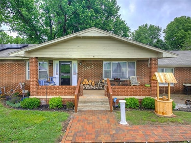 View of front facade with covered porch and brick 