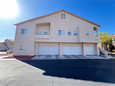 View of front of home with a garage and stucco sid