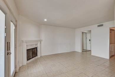 Unfurnished living room with a fireplace, light tile patterned floors, and recessed lighting