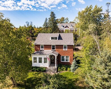 View of front of property with brick siding and a 
