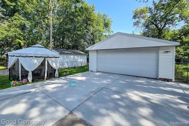 Detached garage with view of wooded area
