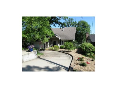 FRONT ELEVATION. Circular drive surrounded with ro