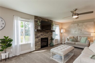 Stone surround gas fireplace in the living room