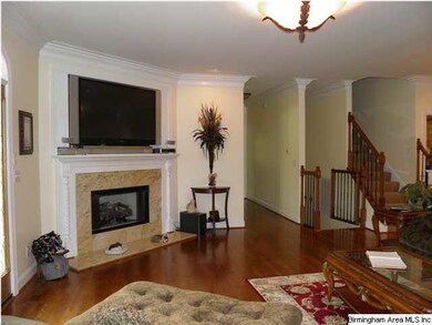 Gleaming hardwood floors, granite fireplace with v