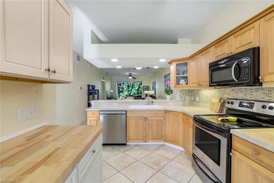 Kitchen with decorative backsplash, appliances wit