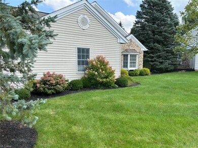View of side of home with a yard