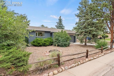 View of front of home with a garage, a shingled roof, and driveway