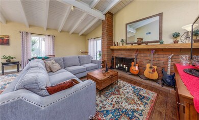 Living room with open beamed, high ceilings.  This home has character.