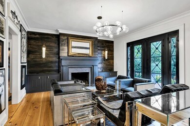 Another view front room w/gas fireplace/doors leading to front patio overlooking front yard. Built ins.