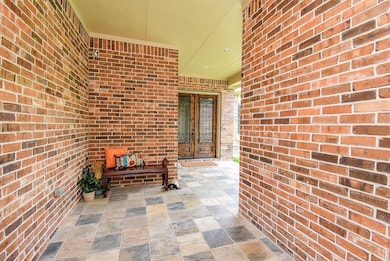 Inviting covered porch entry offers a breezeway of