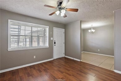 Entryway featuring baseboards, ceiling fan with no