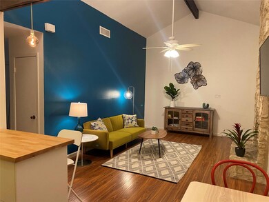 Living area featuring visible vents, a ceiling fa