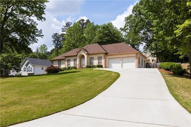 Single story home featuring an attached garage, fe