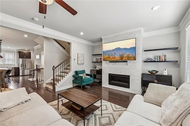 Living area featuring stairway, ornamental molding