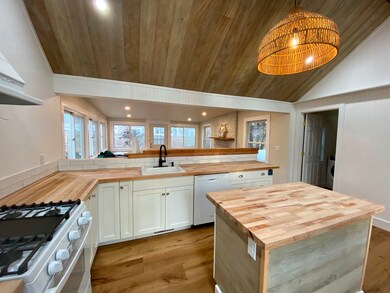 Kitchen with view to family room and door to powder room