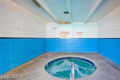 View of pool with a patio area and an in-ground hot tub