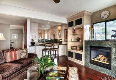 Living room has gas burning fireplace, media and d