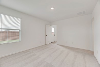 Spare room with light colored carpet and recessed lighting