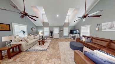 Tiled living room with high vaulted ceiling and ce