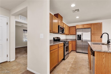 Kitchen with stainless steel appliances, light sto