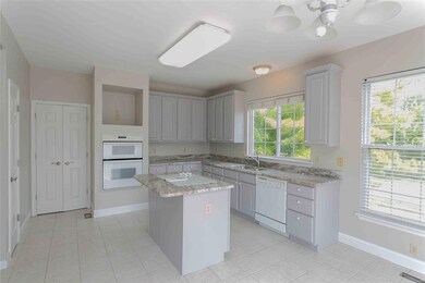 Big kitchen has TV niche, pantry and tile floors
